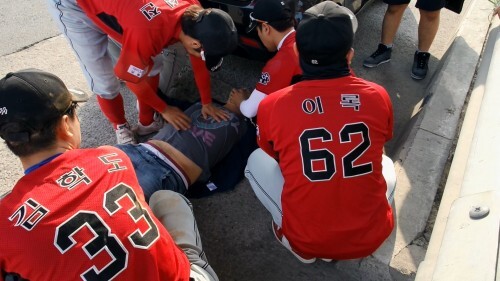 연예인 야구단 공놀이야 선수들이 6일 오후 고양 킨택스 야구장 인근에서 쓰러진 한 남성을 눕힌 뒤 응급처치를 하고 있다. (개그맨 차승환 제공)