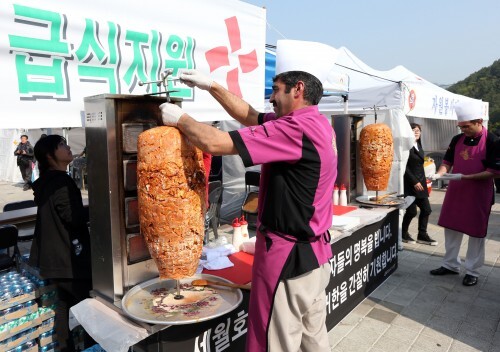 사진=뉴스1 24일 전남 진도실내체육관 앞에서 급식 자원봉사에 나선 주한 터키인들이 케밥을 조리하고 있다.